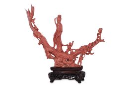 A CORAL CARVING OF GUANYIN WITH CHILDREN ON A DRAGON
