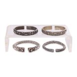 A GROUP OF FOUR CHINESE SILVER BANGLES