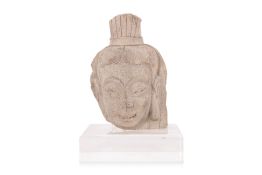 A STONE HEAD OF A BODHISATTVA