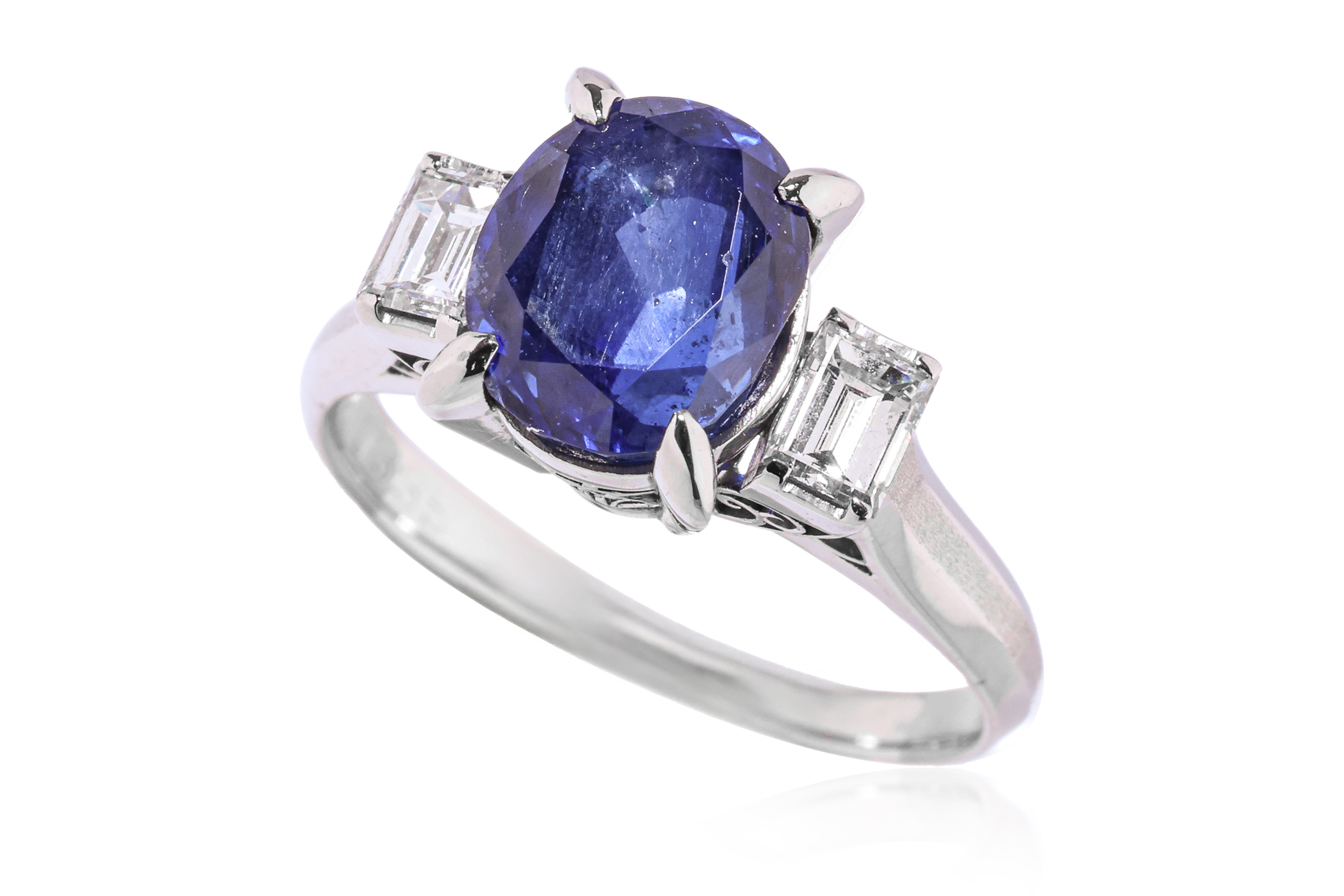 A BLUE SAPPHIRE AND DIAMOND THREE STONE RING