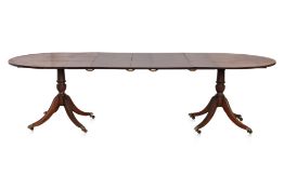 A REGENCY STYLE TWIN PEDESTAL MAHOGANY DINING TABLE