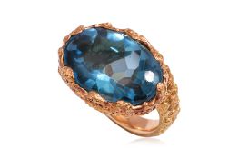 A LARGE BLUE TOPAZ AND TEXTURED GOLD RING