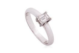 AN EMERALD CUT DIAMOND SOLITAIRE RING