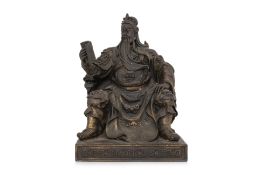 A BRONZE SEATED GUANDI