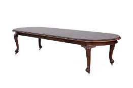 A LARGE CARVED TEAK EXTENDING DINING TABLE