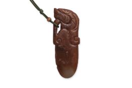 AN ARCHAISTIC CARVED JADE PENDANT