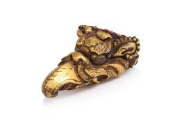 A TIBETAN GILT-COPPER HEAD OF A MAKHARA