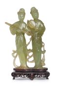 A SERPENTINE JADE CARVING OF TWO LADIES