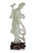 A SERPENTINE JADE FIGURE OF A LADY