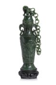 A SPINACH JADE VASE AND COVER WITH CHAIN