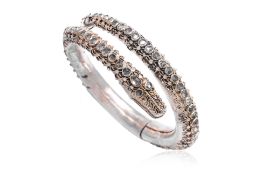 A SILVER AND CLEAR CRYSTAL DRAGON-FORM BANGLE
