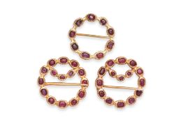 A SET OF THREE SILVER-GILT AND RUBY KEROSANG BROOCHES