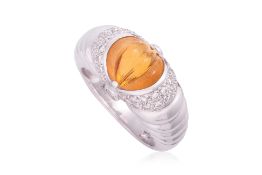 A CARVED CITRINE AND DIAMOND RING