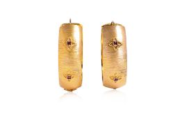 A PAIR OF VERY LARGE RUBY AND TEXTURED GOLD HOOP EARRINGS