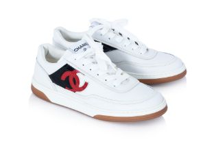 CHANEL - A PAIR OF WHITE RED AND BLACK SNEAKERS