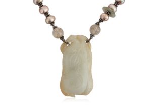 A CELADON JADE PENDANT ON BEADED NECKLACE