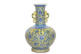 A LARGE YELLOW GROUND AND UNDERGLAZE BLUE LOTUS AND BAJIXIANG VASE