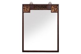 A HARDWOOD FRAMED MIRROR WITH CARVED DECORATION