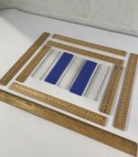 A pallet of assorted wooden and plastic rulers.