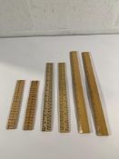 A pallet of assorted wooden rulers.