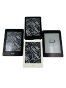 Four pre-owned Amazon Kindle E-Readers.