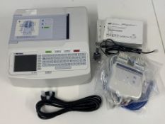 Pre-owned Mortara Eli 150c Electrocardiograph with a Mortara AM12 Acquisition Module.