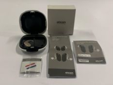 An Oticon Engage BTE Hearing and White Case.