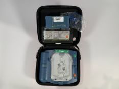 Pre-owned Philips Heartstart HS1 Defibrillator with Carry Case and Battery.