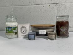 A Collection of Six Scented Candles to include a Benjoin Bougie Parfumee 190g, a Yankee Candle Clean