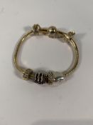 A pre-owned Pandora Bracelet and four Charms.