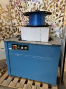 A Preowned Semi-Automatic Strapping Machine (TP-201CE) with banding.