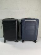 Two pre-owned Samsonite wheeled hard shelled suitcases.