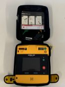 A Pre-owned Physio Control LifePak 1000 Defibrillator (REF: 99425 - 000096) and a Physio Control 100