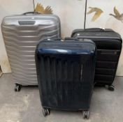Three preowned Samsonite hard shell wheeled suitcases.