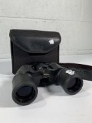 A pair of preowned Nikon Acucon A211 10 X 42 binoculars with case.