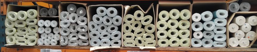 Approximately one hundred rolls of assorted wallpaper.