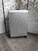 A pre-owned Tumi Aluminum wheeled suitcase (please note some damage dents, scratches).