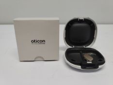 An as new Oticon Engage BTE hearing aid in a Beige and White case.