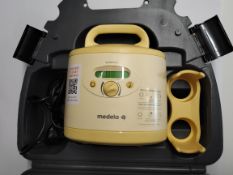 A pre-owned Medela Symphony Double Electric Breast Pump with hard carry case.