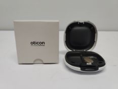 An as new Oticon Engage BTE hearing aid in a Beige and White case.