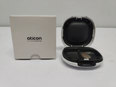 An as new Oticon Engage BTE hearing aid in a Beige and White case.