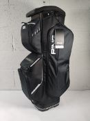 A boxed as new Ping Traverse cart bag in black.