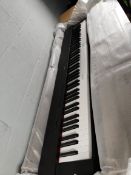 A Yamaha P-225B stage piano.