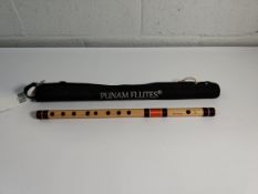 A pre-owned Punam Aurora Bansuri flute with travel case.