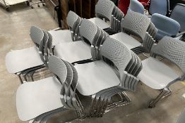 Thirty two stackable plastic chairs with chrome legs.