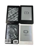Four pre-owned Amazon Kindle E-Readers.