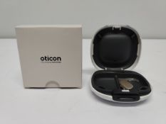 An as new Oticon Engage BTE hearing aid in a Beige and White case.