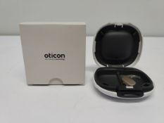 An as new Oticon Engage BTE hearing aid in a Beige and White case.