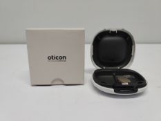 An as new Oticon Engage BTE hearing aid in a Beige and White case.