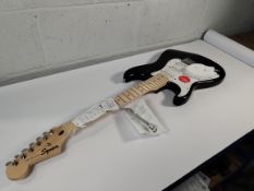 An as new Squier left handed Sonic Stratocaster, MN, black.